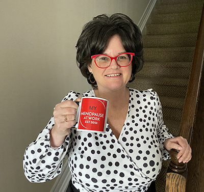 Darlene holding a My Menopause at Work mug